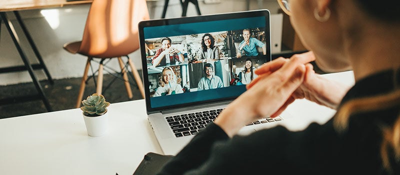 Man attending a meeting remotely from home